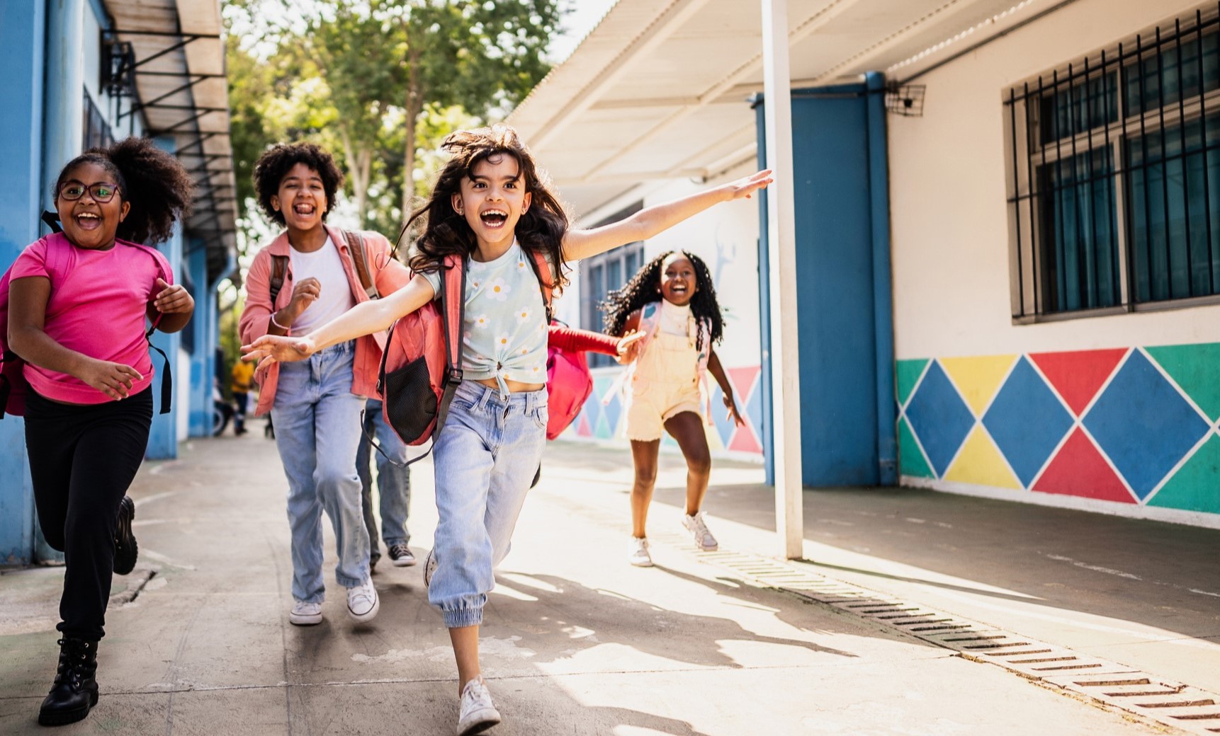smiling children holding boxes for clothes donation event and community food drive