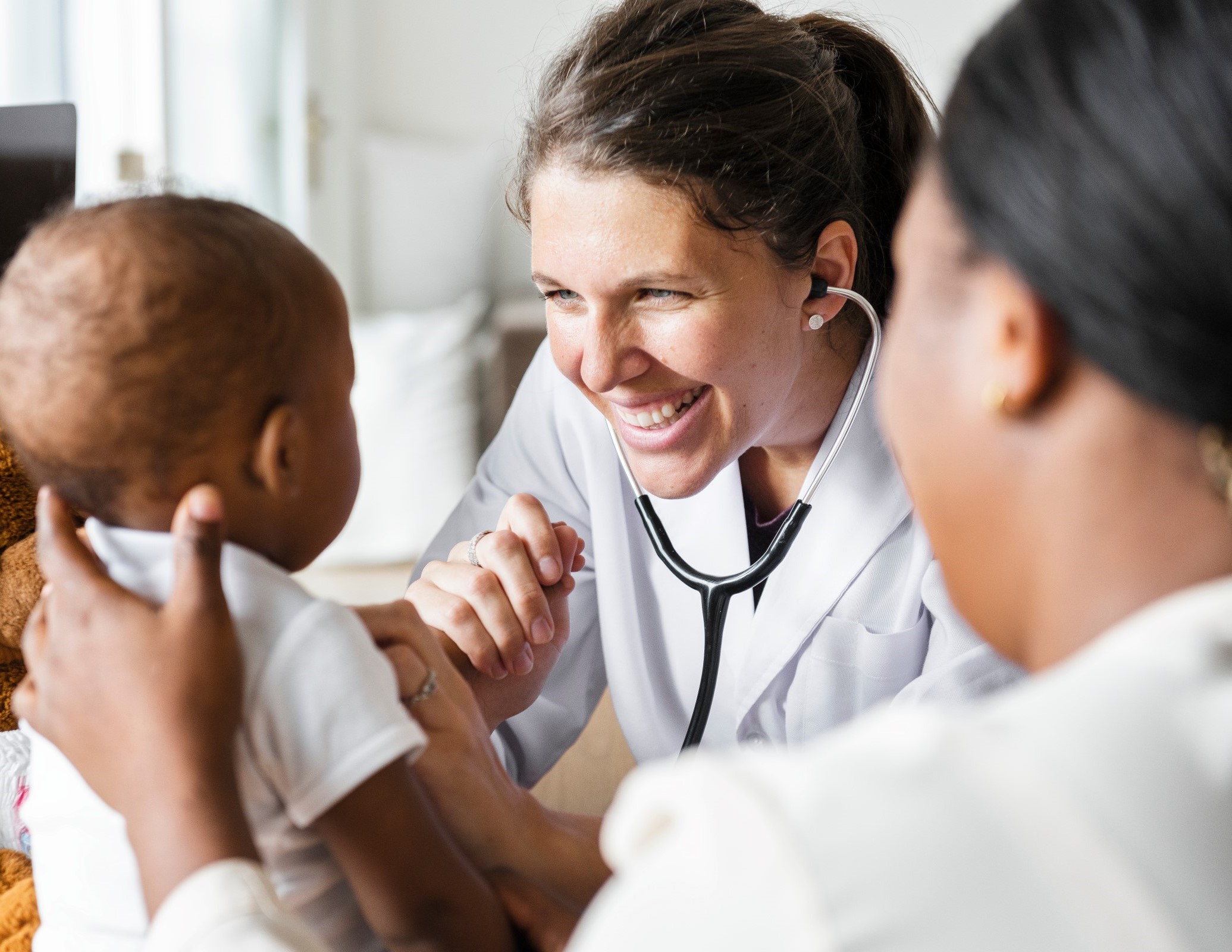 cheerful doctor examines baby