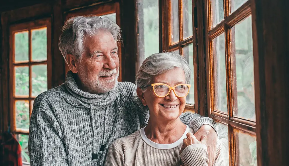 Smiling senior couple looking out the window