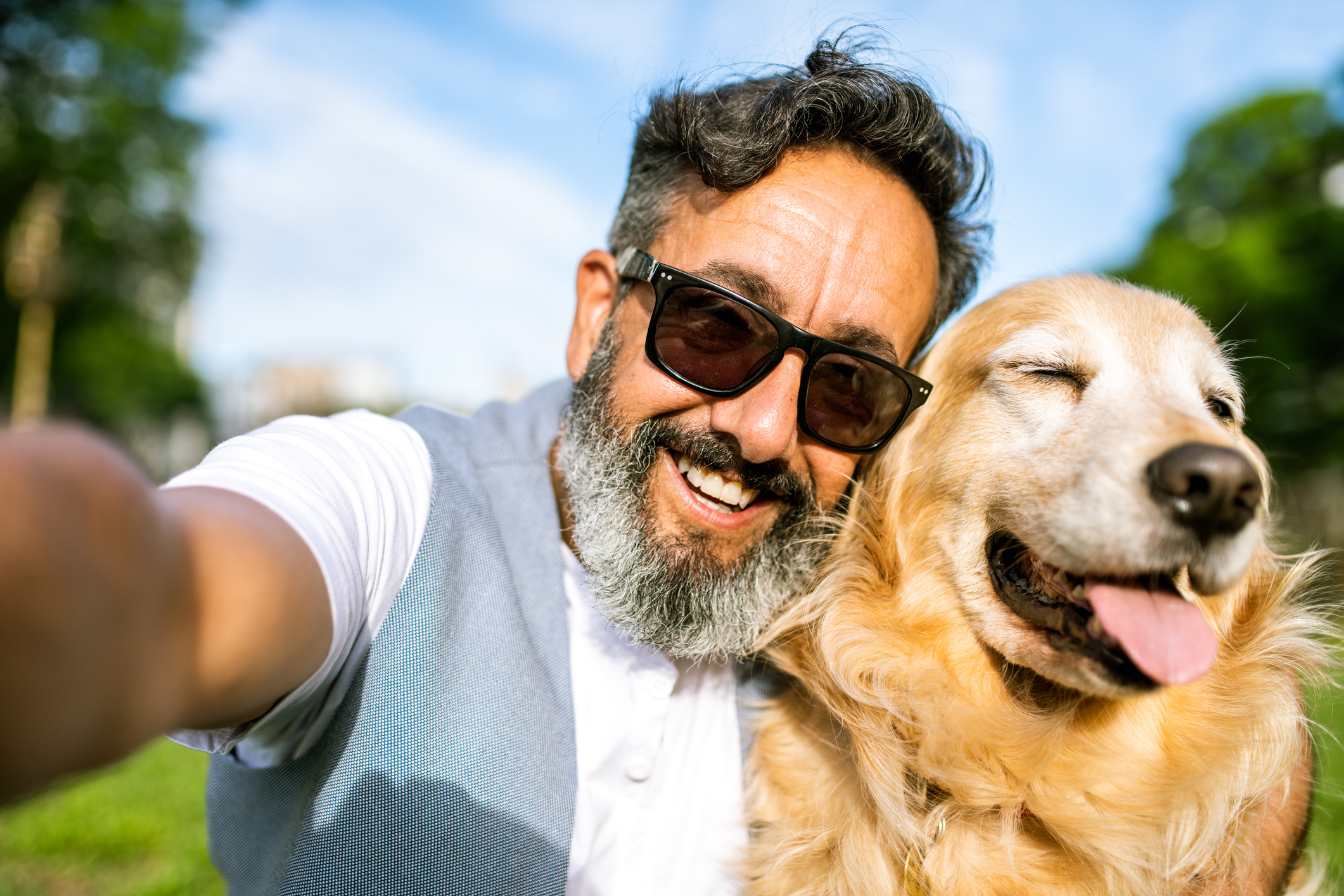 Senior man taking selfie with his dog
