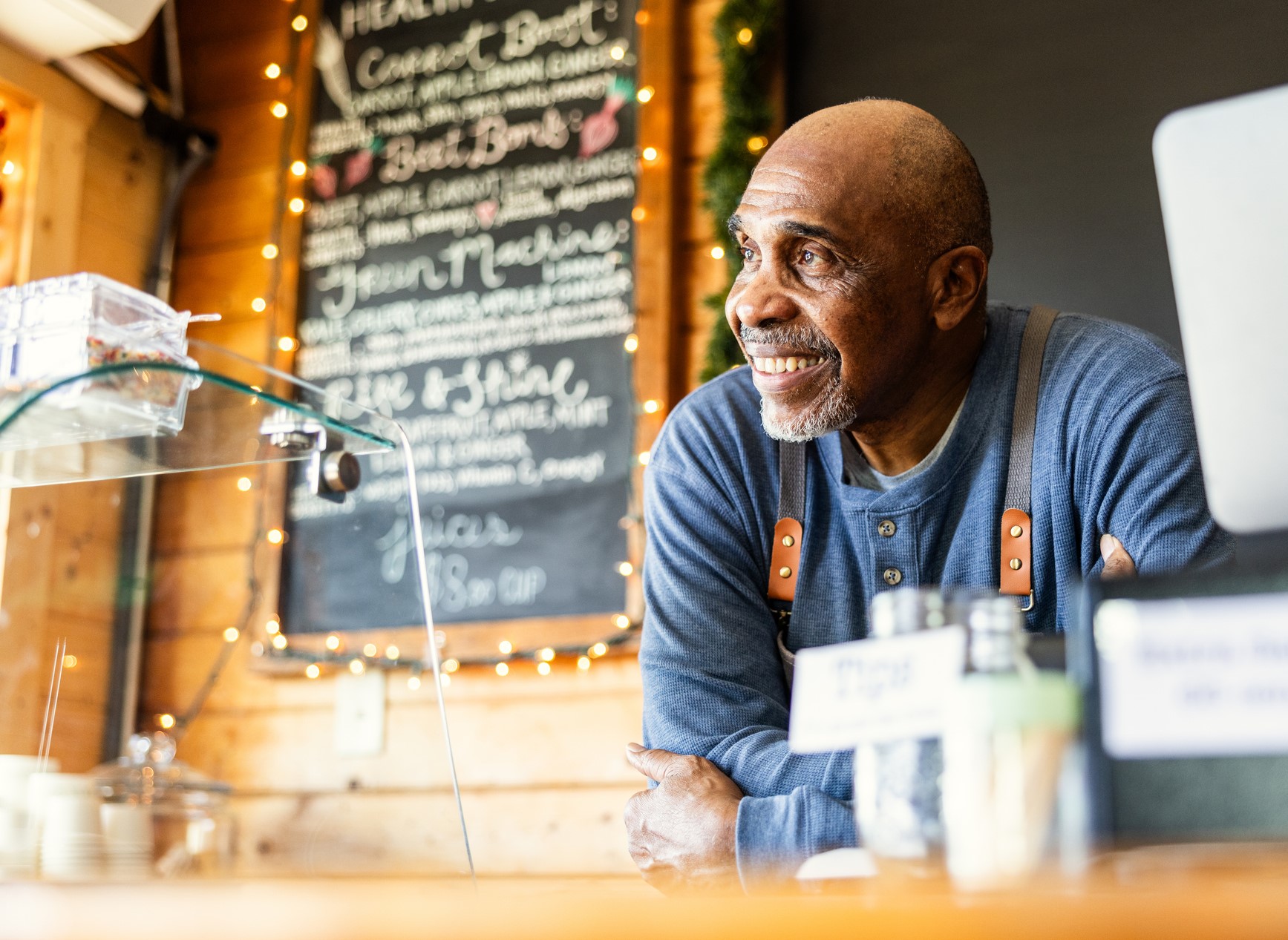 smiling man looking out his foodtruck window